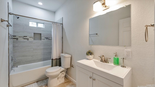 full bathroom featuring shower / bath combo with shower curtain, vanity, and toilet