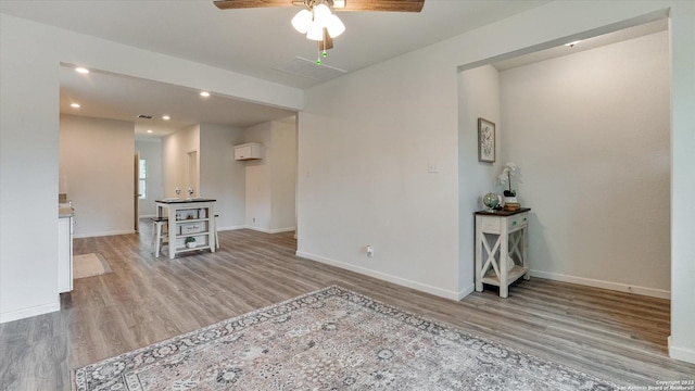 living room featuring light hardwood / wood-style floors and ceiling fan