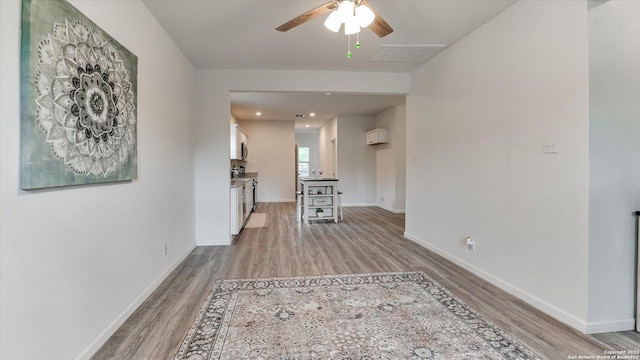 corridor with light hardwood / wood-style flooring