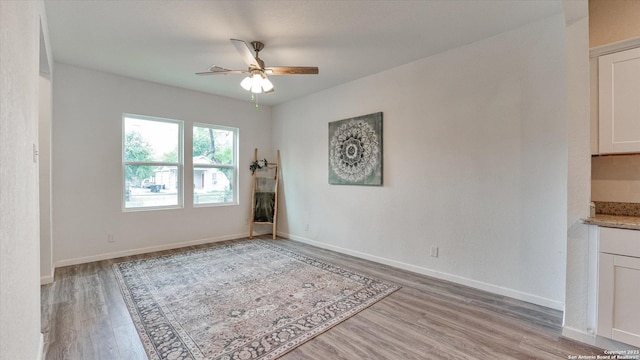 spare room with ceiling fan and light hardwood / wood-style flooring