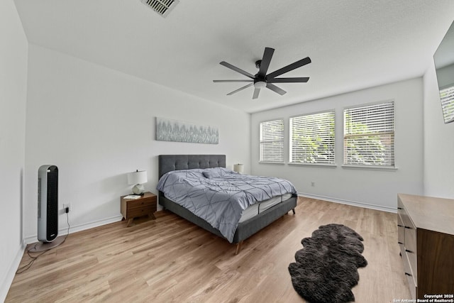 bedroom with ceiling fan and light wood-type flooring