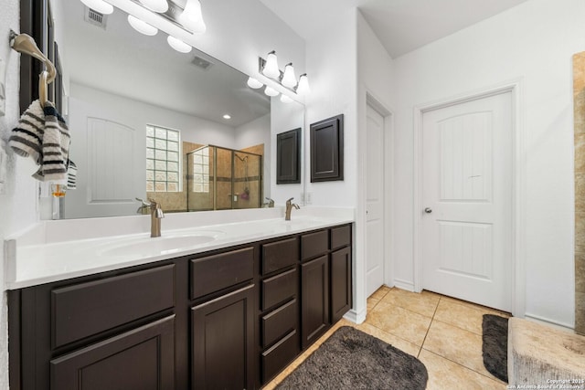 bathroom featuring tile patterned floors, vanity, and an enclosed shower