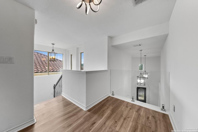 interior space with hardwood / wood-style floors and a notable chandelier