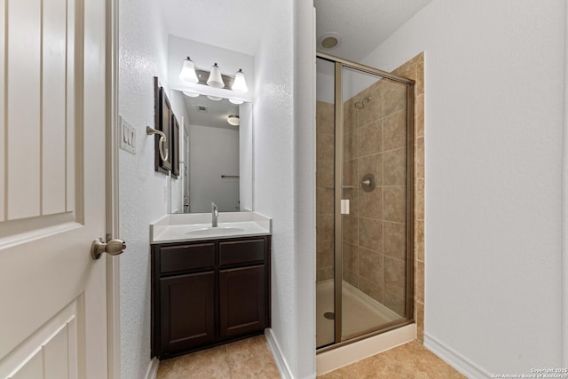 bathroom featuring tile patterned flooring, vanity, and a shower with door