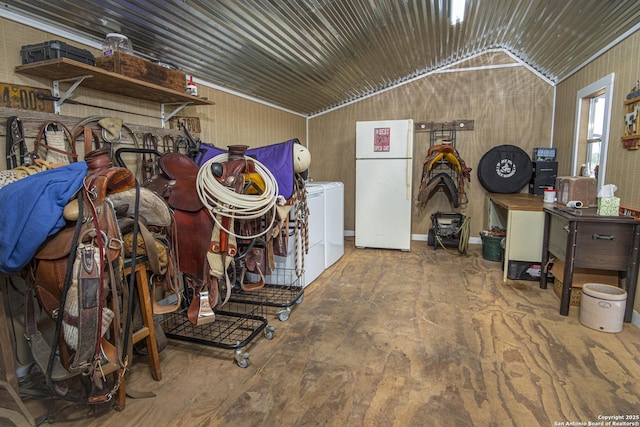 garage with white refrigerator and wooden walls