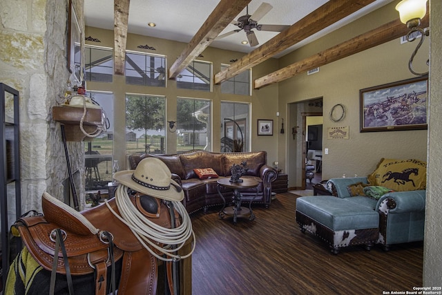 living room with a high ceiling, ceiling fan, dark hardwood / wood-style flooring, and beam ceiling