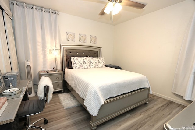 bedroom with ceiling fan, a closet, and wood-type flooring