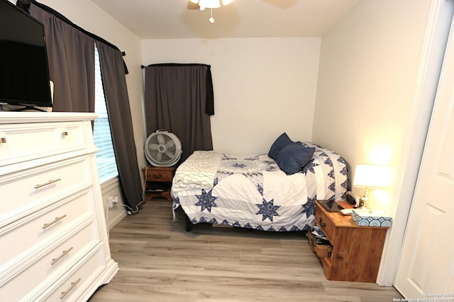 bedroom with ceiling fan and light hardwood / wood-style flooring