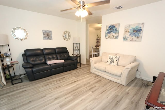 living room featuring ceiling fan and light hardwood / wood-style flooring