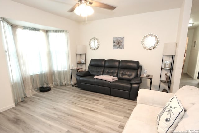 living room featuring ceiling fan and light wood-type flooring