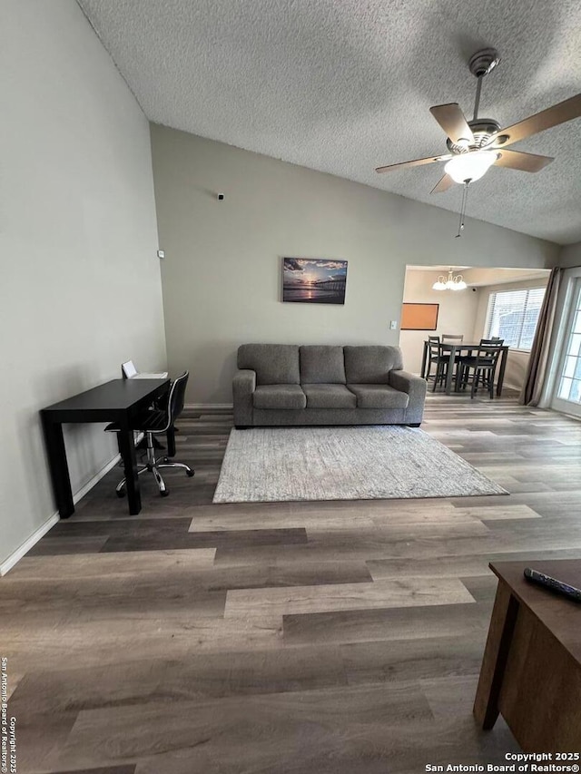 living room with vaulted ceiling, dark wood-type flooring, and a textured ceiling