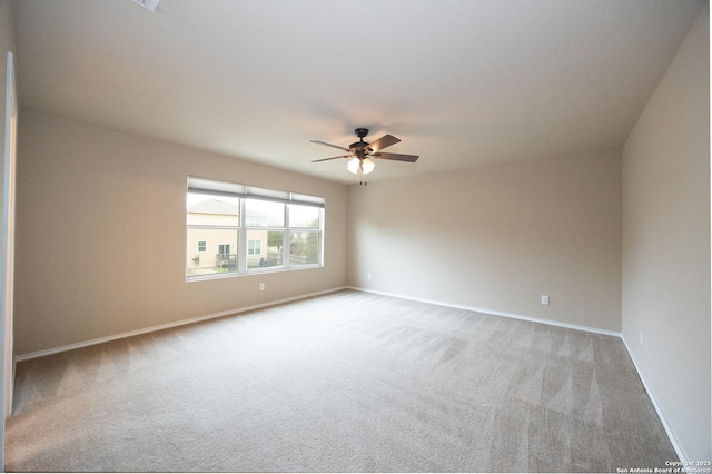 carpeted spare room with ceiling fan