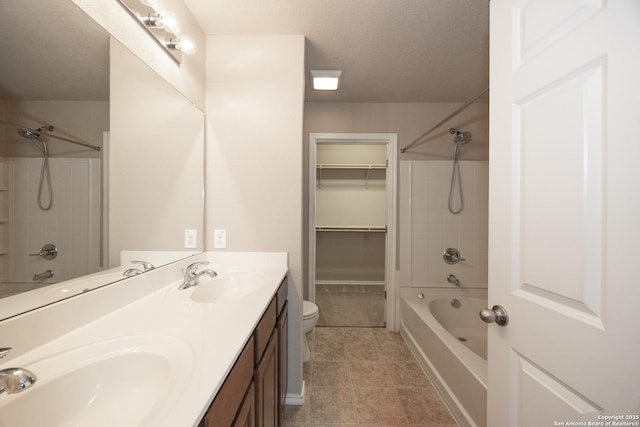 full bathroom with vanity, bathtub / shower combination, a textured ceiling, and toilet