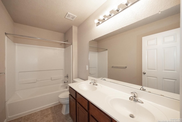 full bathroom with vanity, a textured ceiling, toilet, and tub / shower combination