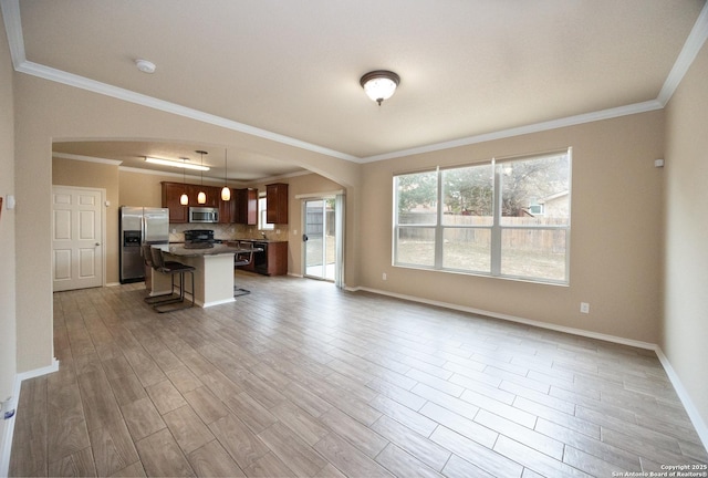 unfurnished living room with ornamental molding and light hardwood / wood-style flooring