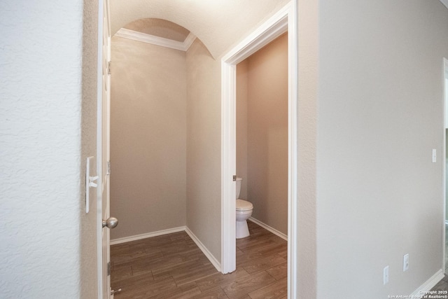 bathroom with hardwood / wood-style floors, toilet, and crown molding