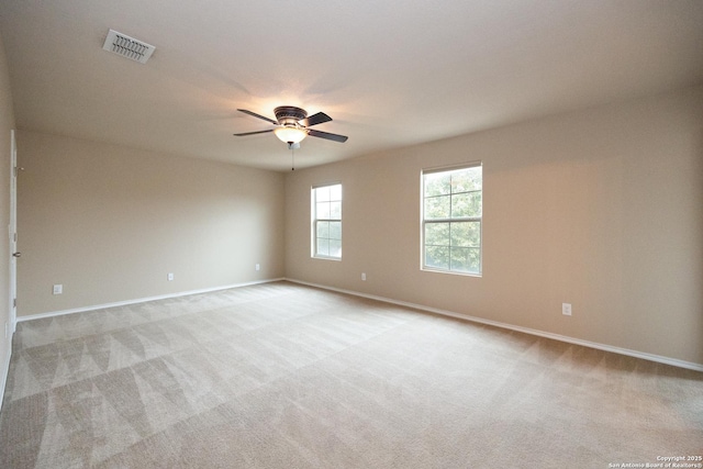 unfurnished room with ceiling fan and light carpet