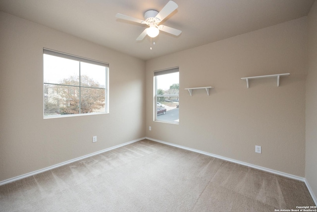 carpeted empty room featuring ceiling fan