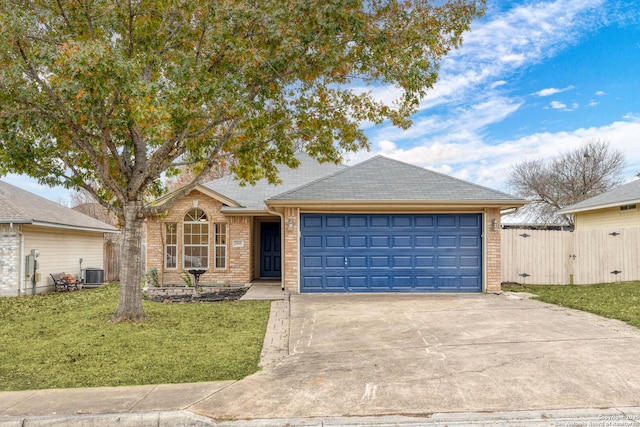 ranch-style home featuring a front yard, a garage, and central air condition unit