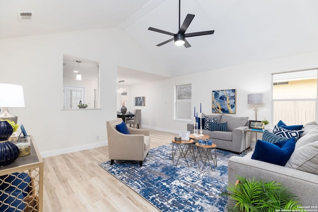 living room with beam ceiling, hardwood / wood-style flooring, high vaulted ceiling, and ceiling fan