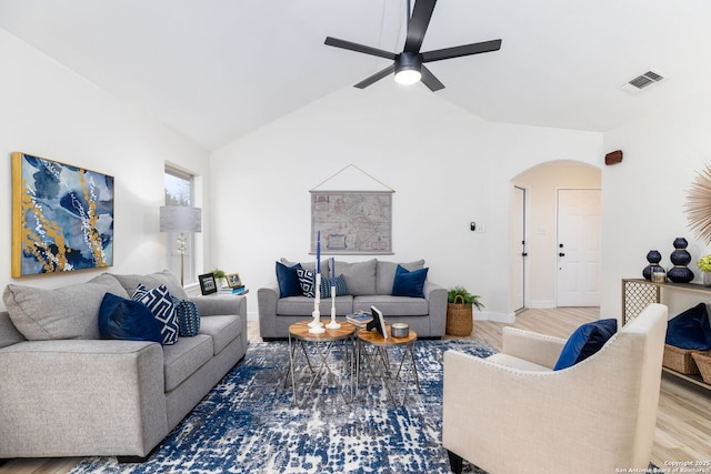 living room with hardwood / wood-style flooring, ceiling fan, and lofted ceiling