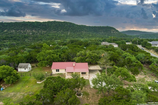 aerial view at dusk featuring a mountain view