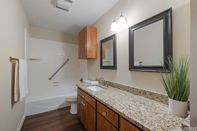 full bathroom featuring vanity,  shower combination, hardwood / wood-style flooring, and toilet