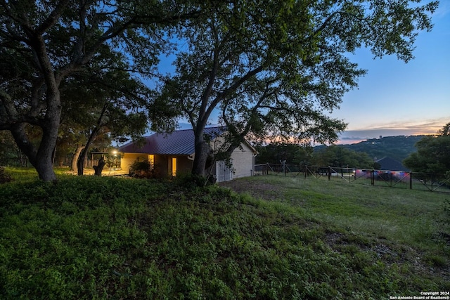 yard at dusk featuring a mountain view