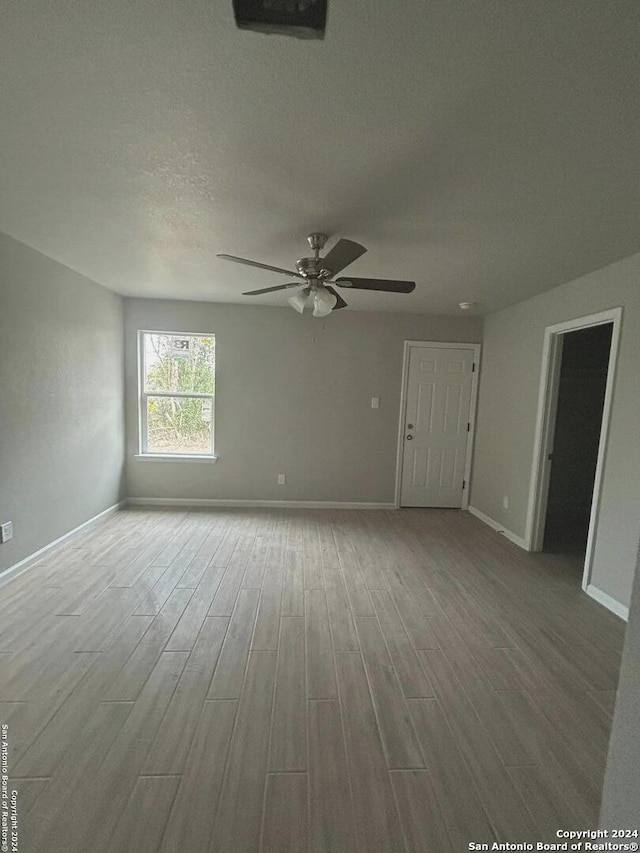 spare room featuring ceiling fan, a textured ceiling, and hardwood / wood-style flooring