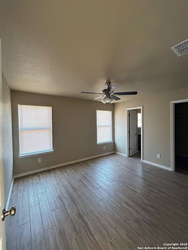 unfurnished room featuring wood-type flooring, a textured ceiling, and ceiling fan