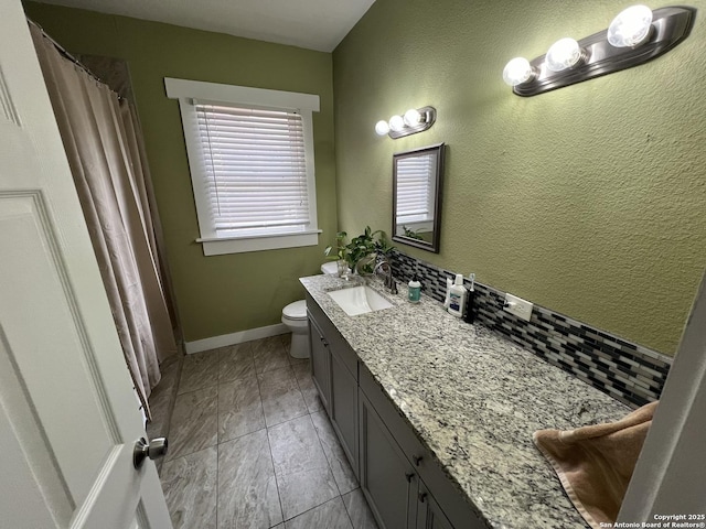 bathroom featuring tile patterned floors, vanity, and toilet