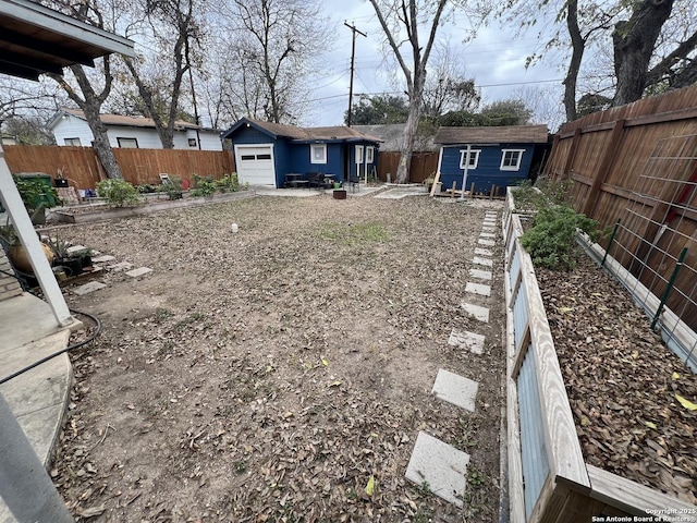 view of yard featuring an outbuilding and a garage