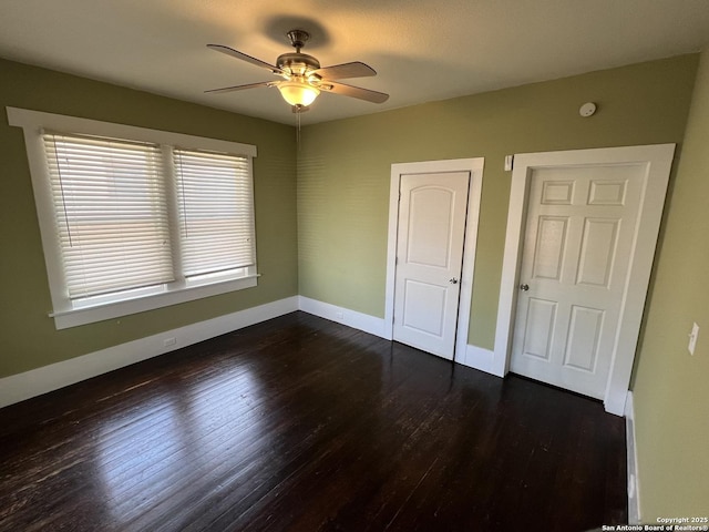 unfurnished bedroom featuring ceiling fan and dark hardwood / wood-style floors