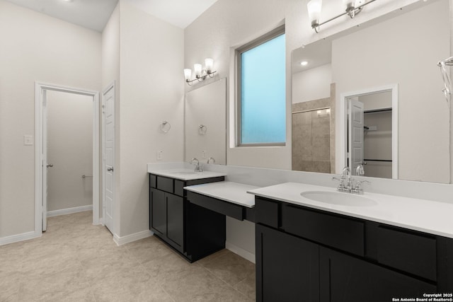 bathroom with tiled shower and vanity