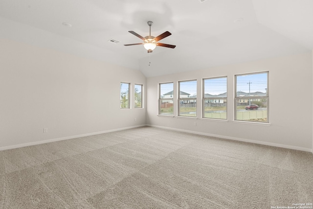 unfurnished room with lofted ceiling, ceiling fan, and carpet