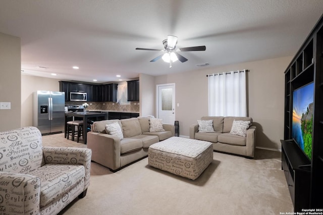 living room featuring ceiling fan and light colored carpet