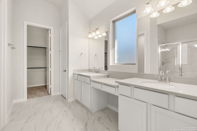 bathroom featuring vanity and a shower with shower door