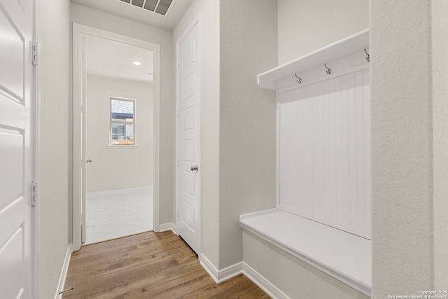 mudroom with light hardwood / wood-style floors