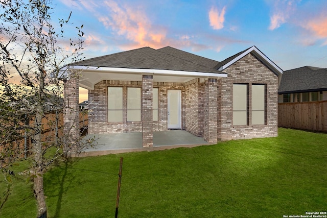 view of front of house with a yard and a patio