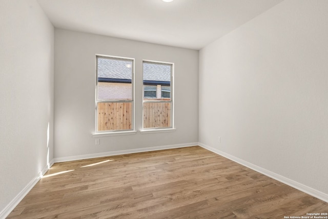 spare room with light wood-type flooring