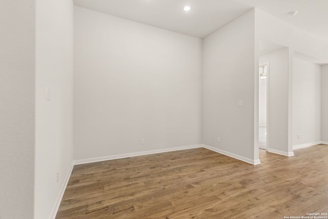 empty room with hardwood / wood-style flooring