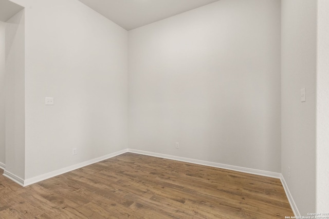 unfurnished room featuring hardwood / wood-style flooring