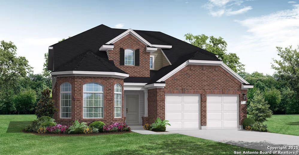 view of front of home with a garage and a front lawn