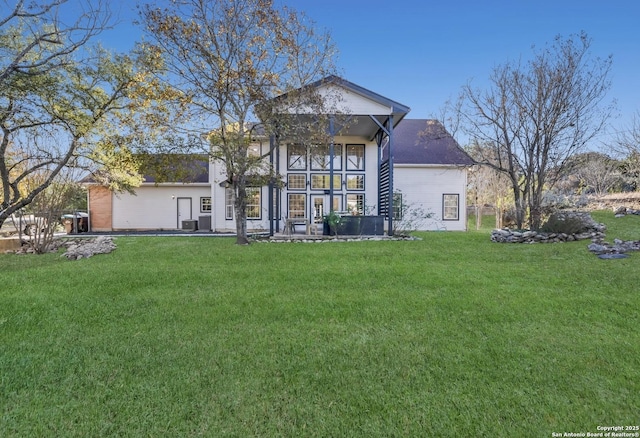 back of house with a lawn