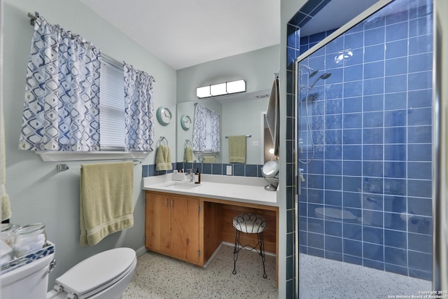 bathroom with vanity, an enclosed shower, and toilet