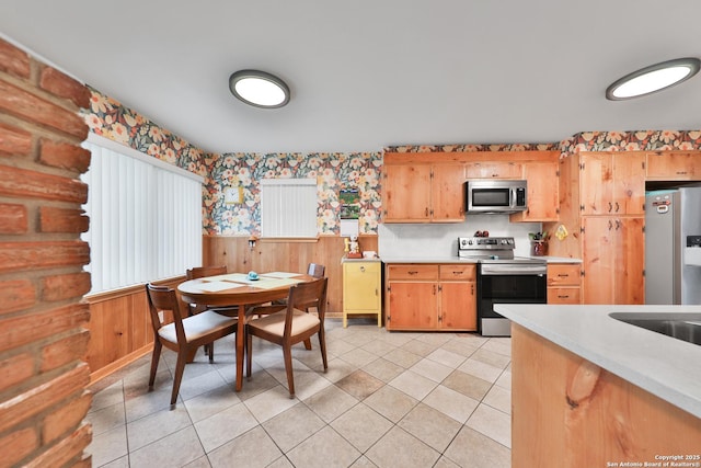 kitchen with light tile patterned floors and appliances with stainless steel finishes