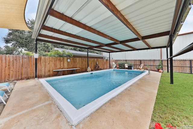 view of pool with a yard