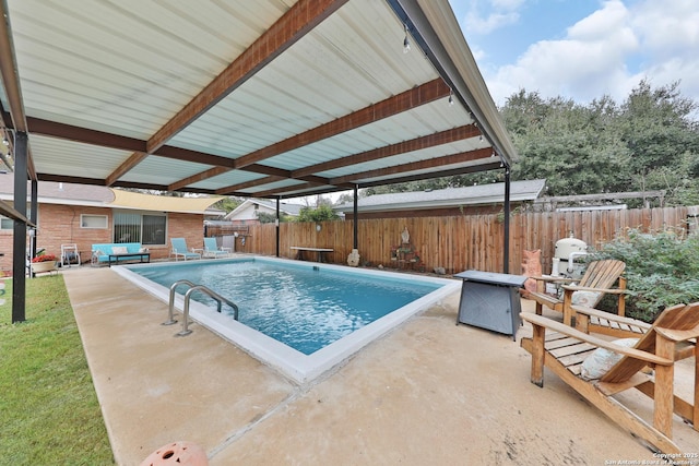 view of swimming pool featuring a diving board and a patio area