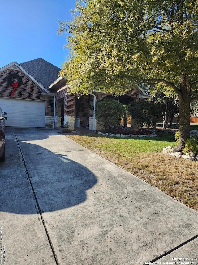 view of front of home featuring a garage and a front lawn