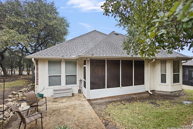 back of property with a patio and a sunroom